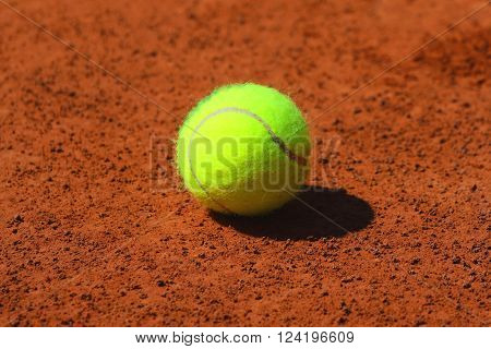 Tennis ball at red clay tennis court