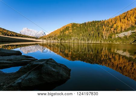 Mountain panorama from Italian Alps. Reflections on water from 