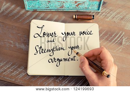 Retro effect and toned image of a woman hand writing on a notebook. Handwritten quote Lower your voice and strengthen your argument as inspirational concept image