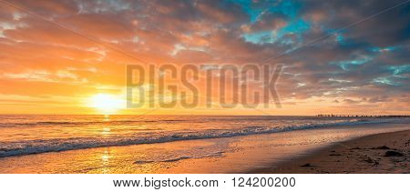 Beautiful dramatic sunset at Glenelg Beach South Australia. Color toning applied
