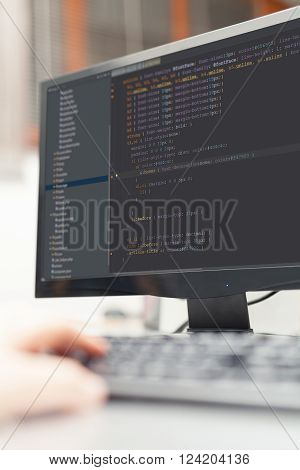 developer working on source codes on computer at office