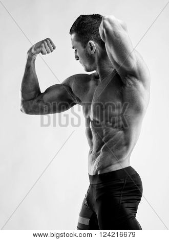 Bodybuilder Man Posing, Showing Perfect Abs, Houlders, Biceps, Triceps, Chest