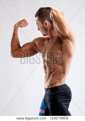 Bodybuilder Man Posing, Showing Perfect Abs, Houlders, Biceps, Triceps, Chest