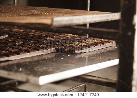 Close Up Of Freshly Baked Cooled Homemade Artisan Professional Chocolate Pads On Steel Trays In Cond