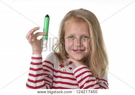 sweet beautiful female child 6 to 8 years old with blonde hair and blue eyes holding drawing - writing marker isolated on white background in education and primary or junior school supplies concept