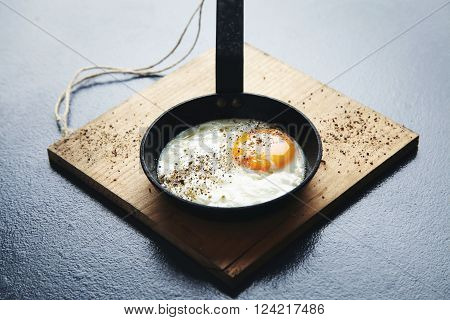 Close View Tasty Healthy Breakfast: Spiced With Pepper Fried Egg In Mini Cast Iron Vintage Pan On Wo