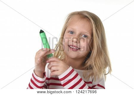 sweet beautiful female child 6 to 8 years old with blonde hair and blue eyes holding drawing - writing marker isolated on white background in education and primary or junior school supplies concept