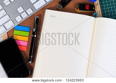 Mobile Phone, Keyboard, Notebook, Thumb Drive And Pen On A Table.