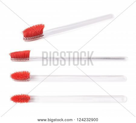Well-worn transparent plastic toothbrush with a used red bristles isolated over the white background, set of four different foreshortenings