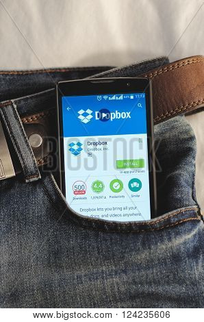 SARANSK, RUSSIA - April 3, 2016: Photo of Smartphone in a jeans pocket with Dropbox application in a Google Play Store on the screen.