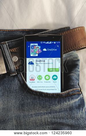 SARANSK, RUSSIA - April 3, 2016: Photo of Smartphone in a jeans pocket with OneDrive application in a Google Play Store on the screen.