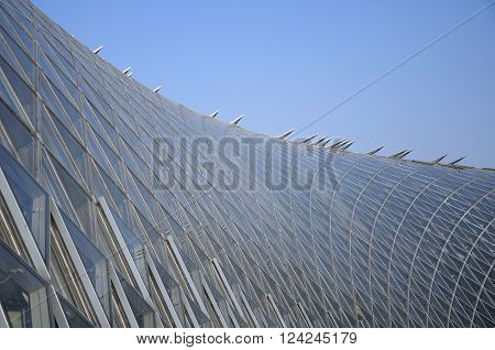 The uniquely designed greenhouse against a blue sky within Chenshan Botanical Gardens located in Songjiang district of shanghai china.