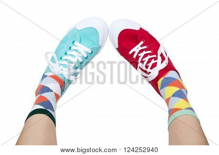 wearing funny socks and different sneakers on legs