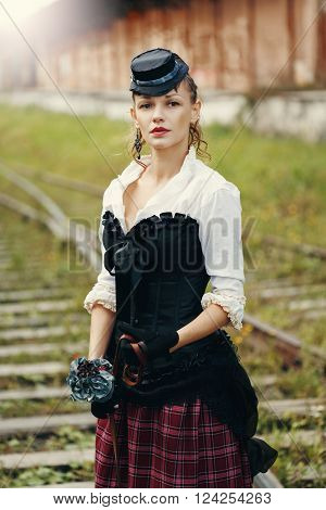Beautiful Woman in Historical Garment Standing on the Abandoned Railway Station. Book Cover Concept.