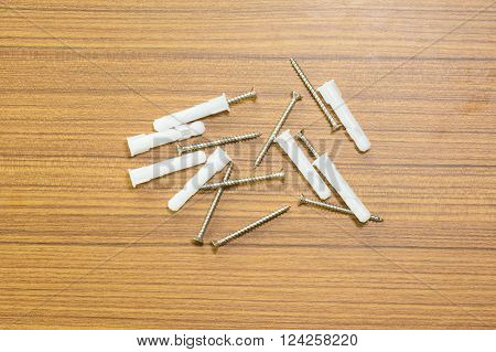 The salf tapping screw on wood background.