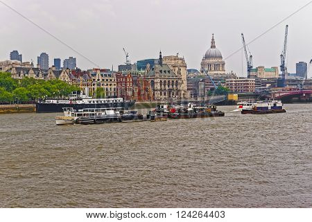 Northern Bank of River Thames with St Paul Cathedral in London UK. Saint Paul Cathedral is an Anglican church the seat for the Bishop of London. It is one of the most famous London sights.