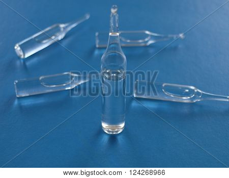 Transparent medical ampoules on a blue background
** Note: Shallow depth of field