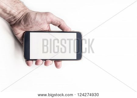 Hand holding mobile smartphone with blank screen horizontally on white background