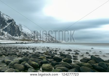 Scenic pebble beach in Eggum Lofoten Islands Arctic Norway Scandinavia Europe on a cloudy winter day.