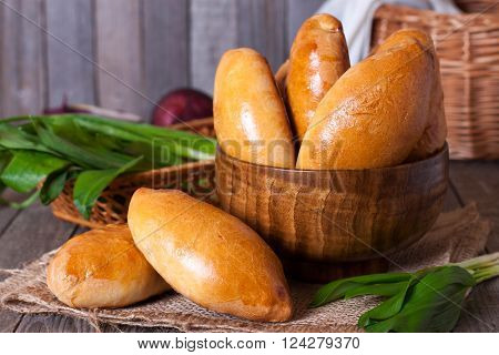 Russian pastries (pirogi) filled with eggs and green onion, closeup