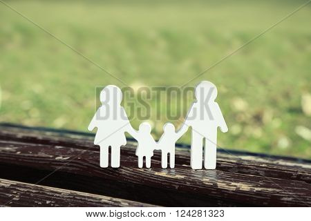 Family figures on a bench in park