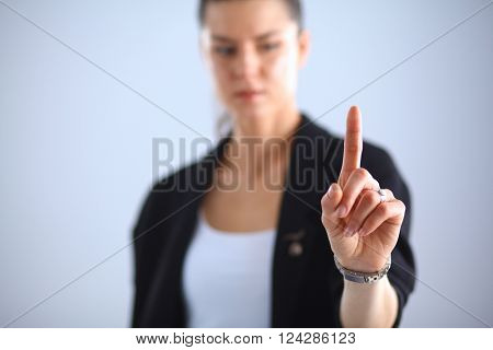 Woman touching an imaginary screen with her finger 