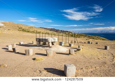 Wide angle view of the Inca's sacrifice table with majestic rural landscape on Island of the Sun Titicaca Lake among the most scenic travel destination in Bolivia. Travel adventures and vacations in the Americas.