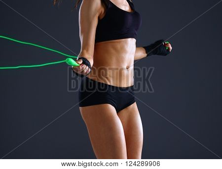 Full length view of an attractive woman with jumping rope