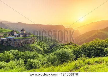 Ancient monastery in setting sun. Tatev. Armenia