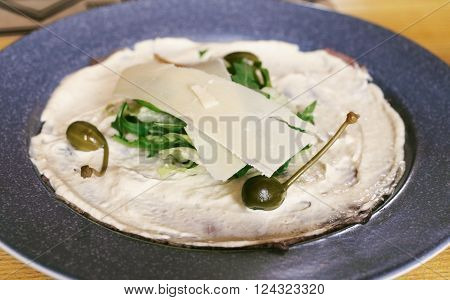 Italian dish Vitello Tonnato pieces of marinated beef seasoned tuna cream sauce