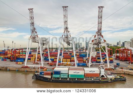 Buenos Aires Argentina - December 16 2012: Cargo ships with shipping containers at a container terminal in Puerto Nuovo Buenos Aires Argentina on a overcast weather.