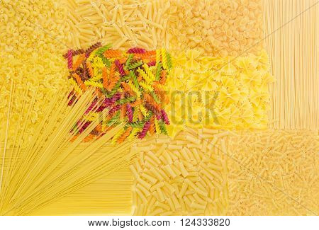 Set of backgrounds of several uncooked pasta different varieties, shapes and colors