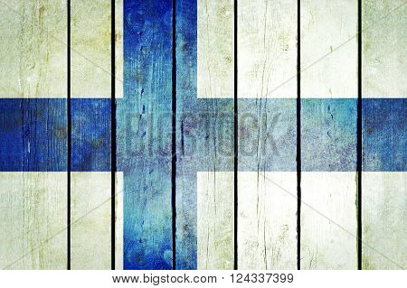 Finland wooden grunge flag. Finland flag painted on the old wooden planks. Vintage retro picture from my collection of flags.