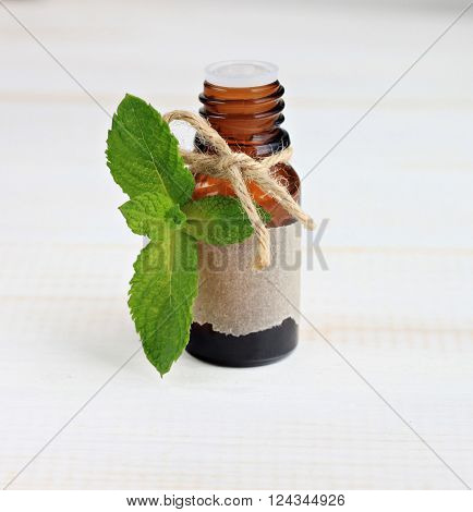 Essential mint oil. Mint fresh herb, essence bottle.