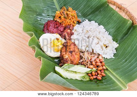 Traditional Nasi Lemak Cuisine On Banana Leaf With Fried Chicken