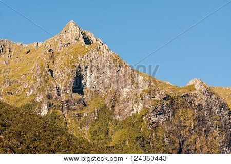 Mountain peak on a  clear sunny day in Fjordland New Zealand