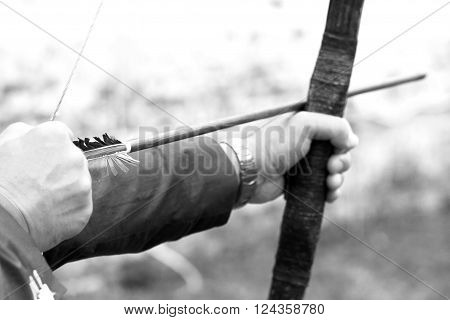 Archer holds his bow, black and white photo