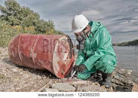 Environmentalist taking sample at chemical pollution hot-spot