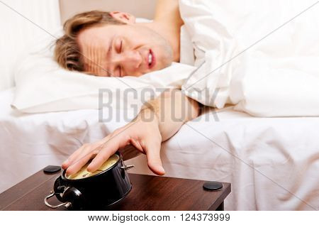 Man trying to sleep, when alarm clock ringing