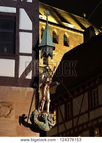 A knight statue at a house corner at the medieval square at the Durer house at night, Nuremberg Germany 2016
