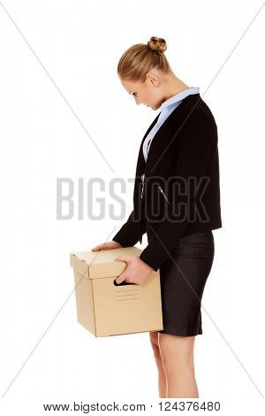 Sad business woman carrying box after loosing job