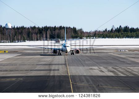 Airplane taking off on runaway the airport in winter