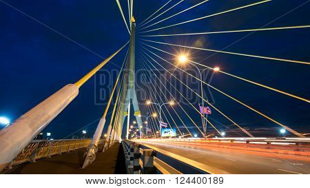 The bridge construction on twilight and river reflection at night Rama 8 Bridge in Bangkok Thailand