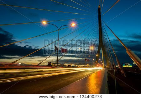 The bridge construction on twilight and river reflection at night Rama 8 Bridge in Bangkok Thailand