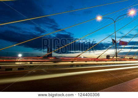 The bridge construction on twilight and river reflection at night Rama 8 Bridge in Bangkok Thailand