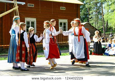 HELSINKI FINLAND - JUNE 20 2012: Unidentified dancers in folklore ensemble in traditional folk costumes at midsummer day festival.