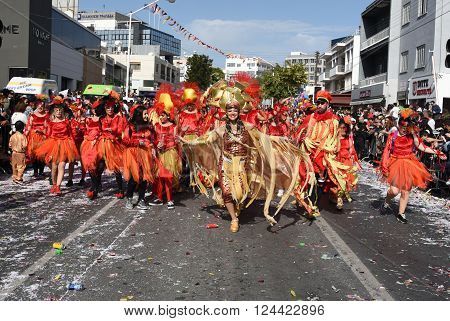 LIMASSOL CYPRUS - MARCH 13: Happy people in teams dressed with colorful costumes at famous Limassol Carnival Parade on March 13 2016 in Limassol town Cyprus.