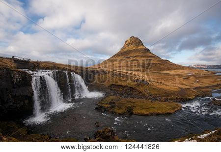 Kirkjufellsfoss waterfalls with the Kirkjufell mountain at Grundarfjordur on the Snaefellsnes peninsula in Iceland.