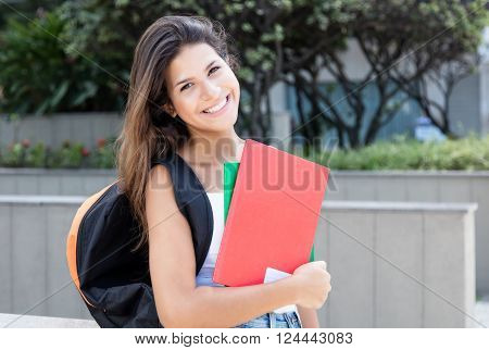 Caucasian female student looking at camera in the city
