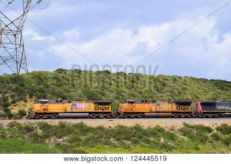 March 29, 2016 in Cajon, CA:  Union Pacific train transporting commerce southbound towards Los Angeles and to the Port of Los Angeles where goods will be exported on freighter ships taken in Cajon, CA